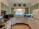 Cozy kitchen featuring vintage cabinets, retro appliances, and classic finishes at 750 Charlie Taylor Rd, Plant City, FL 33566