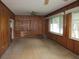 Cozy wood paneled living room with built-in shelves and natural lighting at 750 Charlie Taylor Rd, Plant City, FL 33566