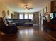 Inviting living room featuring wood floors, fireplace, and comfortable leather seating at 750 Charlie Taylor Rd, Plant City, FL 33566
