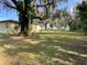 Spacious yard with mature oak trees draped in Spanish moss offering plenty of shade at 750 Charlie Taylor Rd, Plant City, FL 33566