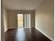 Cozy living area with rich wood floors and sliding glass doors leading to the backyard at 4710 Bloom Dr, Plant City, FL 33566