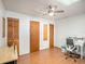 This bedroom has laminated floors, a ceiling fan, and a desk at 250 Rosery Nw Rd # 260, Largo, FL 33770
