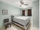 This bedroom features an upholstered bed frame with a chair and ceiling fan at 250 Rosery Nw Rd # 260, Largo, FL 33770