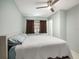 This bedroom features a ceiling fan and neutral color palette with warm brown window coverings at 250 Rosery Nw Rd # 260, Largo, FL 33770
