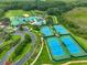 Aerial view of community amenities including pools, tennis courts, and clubhouse at 19245 Wood Sage Dr, Tampa, FL 33647