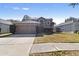 Charming two-story home featuring an attached two-car garage on a sunny day at 19245 Wood Sage Dr, Tampa, FL 33647