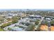 Drone shot of townhomes and pool amidst lush greenery with city skyline backdrop, showing prime location at 2311 W Morrison Ave # 13, Tampa, FL 33629