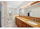 Bathroom with a granite vanity, double sinks, large mirror, and a tub at 2311 W Morrison Ave # 13, Tampa, FL 33629