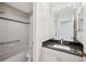 This bathroom features a granite countertop, tiled shower, and exhaust fan at 2311 W Morrison Ave # 13, Tampa, FL 33629