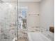 Elegant bathroom showcasing a glass shower, soaking tub, and marble tile at 2311 W Morrison Ave # 13, Tampa, FL 33629