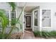 Charming home exterior featuring a tiled front porch and decorative palm trees at 2311 W Morrison Ave # 13, Tampa, FL 33629