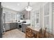 Cozy kitchen with stainless steel appliances, gray cabinets, and bright natural light from plantation shutters at 2311 W Morrison Ave # 13, Tampa, FL 33629