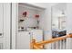 This laundry room includes a modern washer and dryer with shelving for storage at 2311 W Morrison Ave # 13, Tampa, FL 33629