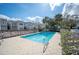 Community pool surrounded by well-maintained townhomes and lush landscaping, creating a relaxing outdoor space at 2311 W Morrison Ave # 13, Tampa, FL 33629