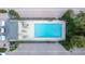 Aerial view of a community pool with lounge chairs and greenery, creating a relaxing outdoor retreat for residents at 2311 W Morrison Ave # 13, Tampa, FL 33629