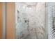 Modern walk-in shower with marbled tile and glass door at 2311 W Morrison Ave # 13, Tampa, FL 33629