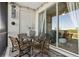 Relaxing outdoor balcony with stylish furniture, string lights, and a scenic view at 11658 Bluestone Ct, Parrish, FL 34219