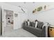 Comfortable living room features a soft gray sofa, closet, and stylish decorations on a shelf at 11658 Bluestone Ct, Parrish, FL 34219