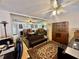 Cozy living room with hardwood floors, ceiling fans, and a decorative rug at 11231 Dollar Lake Dr # 1, Port Richey, FL 34668
