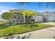 Inviting single-story home featuring manicured lawn and decorative shrubs at 11511 Balintore Dr, Riverview, FL 33579