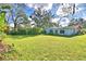 Expansive backyard featuring a well-maintained lawn with views of the home's exterior at 1413 May St, Lutz, FL 33548