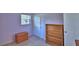 Small bedroom with lavender walls, small closet, and furniture at 1413 May St, Lutz, FL 33548