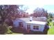 Aerial view of home with mature trees and a spacious backyard with lush green lawn at 1413 May St, Lutz, FL 33548
