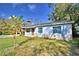 Exterior showcasing a single-story home with a combination of stone accents and siding at 1413 May St, Lutz, FL 33548