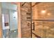 Bathroom features a shower with tiled walls, glass door, and shower caddy at 1413 May St, Lutz, FL 33548