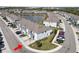 Aerial view of a townhome community featuring a lake with fountain and well-maintained landscaping at 8680 Falling Blue Pl, Riverview, FL 33578