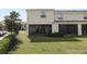 Backyard with green grass, and a cozy screened lanai at 8680 Falling Blue Pl, Riverview, FL 33578