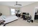 Cozy bedroom with a neutral color scheme, a desk, and an ensuite bathroom at 8680 Falling Blue Pl, Riverview, FL 33578