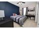 Comfortable bedroom featuring a navy accent wall, neutral carpet, and coordinated decor with a relaxing atmosphere at 8680 Falling Blue Pl, Riverview, FL 33578