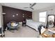 Comfortable bedroom with a chair, fan, and natural light at 8680 Falling Blue Pl, Riverview, FL 33578