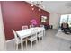 The dining room features a bold accent wall, modern lighting, and opens to a cozy seating area at 8680 Falling Blue Pl, Riverview, FL 33578