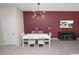 Dining room with eye-catching lighting fixture and modern decor, offering an inviting space for gatherings at 8680 Falling Blue Pl, Riverview, FL 33578