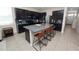 Stylish kitchen with granite island, dark cabinets, and bar seating, perfect for casual dining and entertaining at 8680 Falling Blue Pl, Riverview, FL 33578
