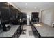 Modern kitchen boasting stainless steel appliances, granite countertops, and sleek dark cabinetry for a luxurious touch at 8680 Falling Blue Pl, Riverview, FL 33578
