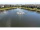 Aerial view featuring a large lake in a townhome community with a fountain at 8680 Falling Blue Pl, Riverview, FL 33578