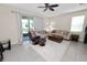 Cozy living room with a sliding glass door leading to the backyard, featuring comfortable seating and neutral colors at 8680 Falling Blue Pl, Riverview, FL 33578