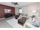 Comfortable living room with a large sliding glass door, neutral decor, and a plush sofa, perfect for relaxation at 8680 Falling Blue Pl, Riverview, FL 33578