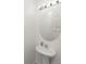 Clean powder room featuring a pedestal sink, oval mirror, and modern lighting fixture at 8680 Falling Blue Pl, Riverview, FL 33578