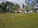 Charming single-story home with a well-manicured lawn and mature trees at 20352 Astoria Ave, Port Charlotte, FL 33952