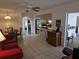 Spacious living room with tile floors provides seamless access to other rooms, enhancing the open layout at 20352 Astoria Ave, Port Charlotte, FL 33952