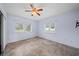 Bedroom featuring tiled floors, a ceiling fan, and natural light from the two windows at 404 Tomahawk Trl, Brandon, FL 33511