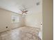 Neutral bedroom with tiled flooring, ceiling fan and natural light from the window at 404 Tomahawk Trl, Brandon, FL 33511