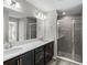 Bathroom with double sink vanity, large mirror and walk-in shower at 6925 161St E Ter, Parrish, FL 34219
