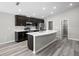 Open kitchen features stainless steel appliances, granite countertops and island with seating at 6925 161St E Ter, Parrish, FL 34219