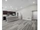 Bright open-concept living room showcasing wood-look floors, stainless steel appliances and neutral paint at 6925 161St E Ter, Parrish, FL 34219