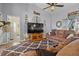 Relaxing living room with hardwood floors, vaulted ceilings, and modern decor at 6929 Northlake Dr, Zephyrhills, FL 33542